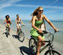 Girls cycling on a beach in Florida