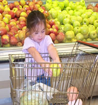 The Fort Campbell Commissary believes in starting their shoppers early.  This photo shows Hunter, one of their first young shoppers, using the new Kiddie Buggies donated by the Kellogg's Company.