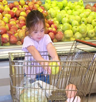 The Fort Campbell Commissary believes in starting their shoppers early. This photo shows Hunter, one of their first young shoppers, using the new Kiddie Buggies donated by the Kellogg's Company.